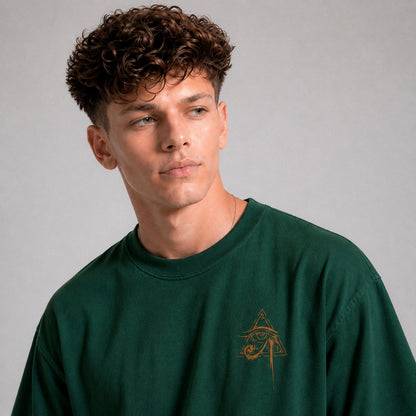 Man wearing a green sweatshirt with a logo on a gray background