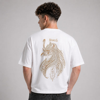 Person wearing a white t-shirt with a gold 'Horus' design on the back against a gray background