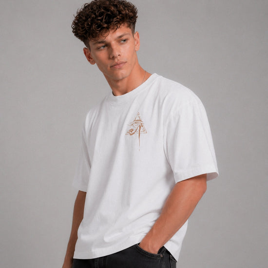 Man wearing a white t-shirt with a small logo on a gray background