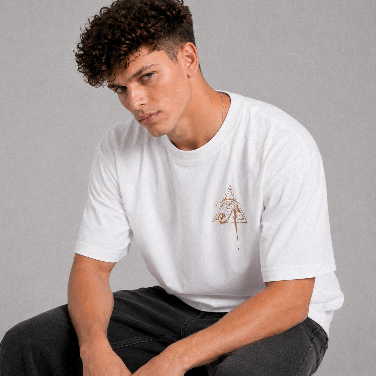 Man wearing a white t-shirt with a logo on a gray background
