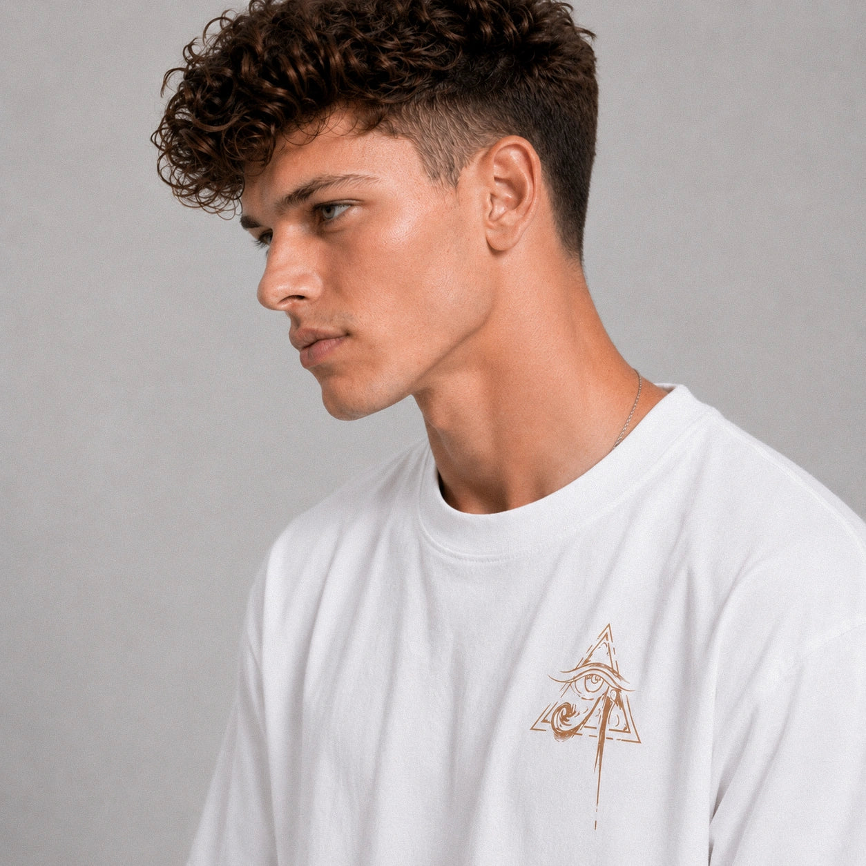 Man wearing a white t-shirt with a logo on a gray background