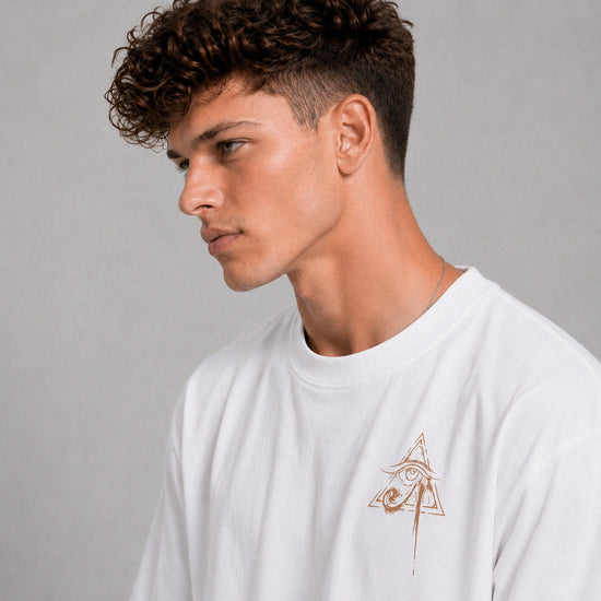 Man wearing a white t-shirt with a logo on a gray background