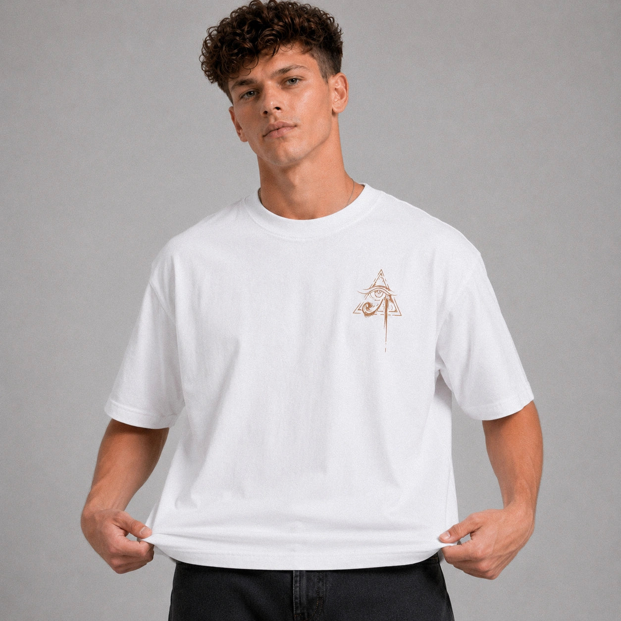 Man wearing a white t-shirt with a small logo on a gray background