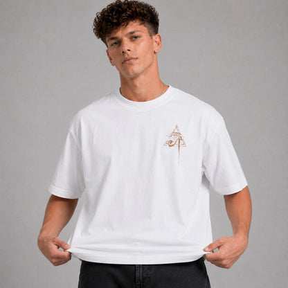 Man wearing a white t-shirt with a small logo on a gray background