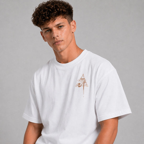 Man wearing a white t-shirt with a small logo on a gray background