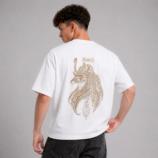 Person wearing a white t-shirt with a detailed design and 'Horus' text on the back, standing against a gray background.
