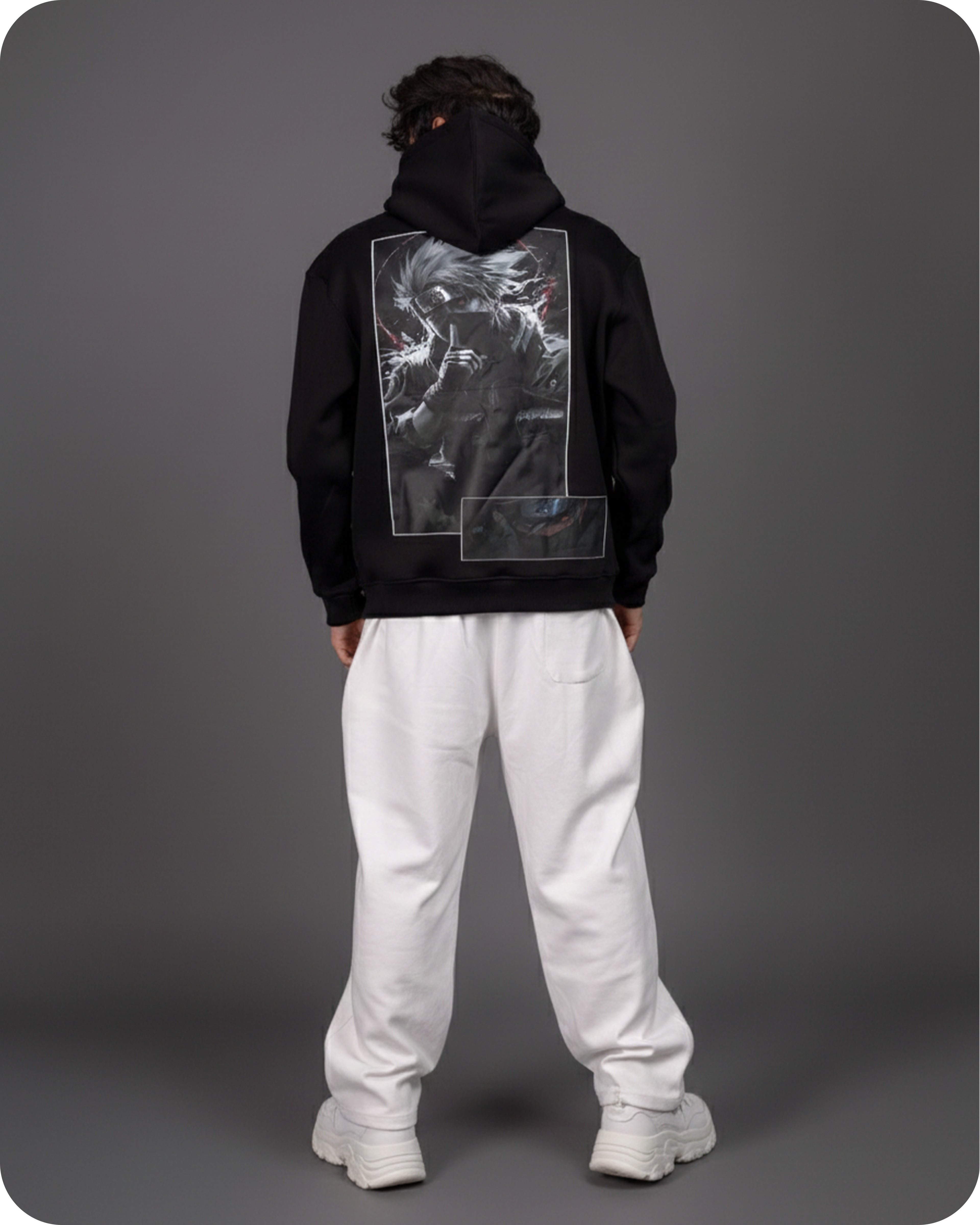 Person wearing a black hoodie with a graphic design on the back against a gray background