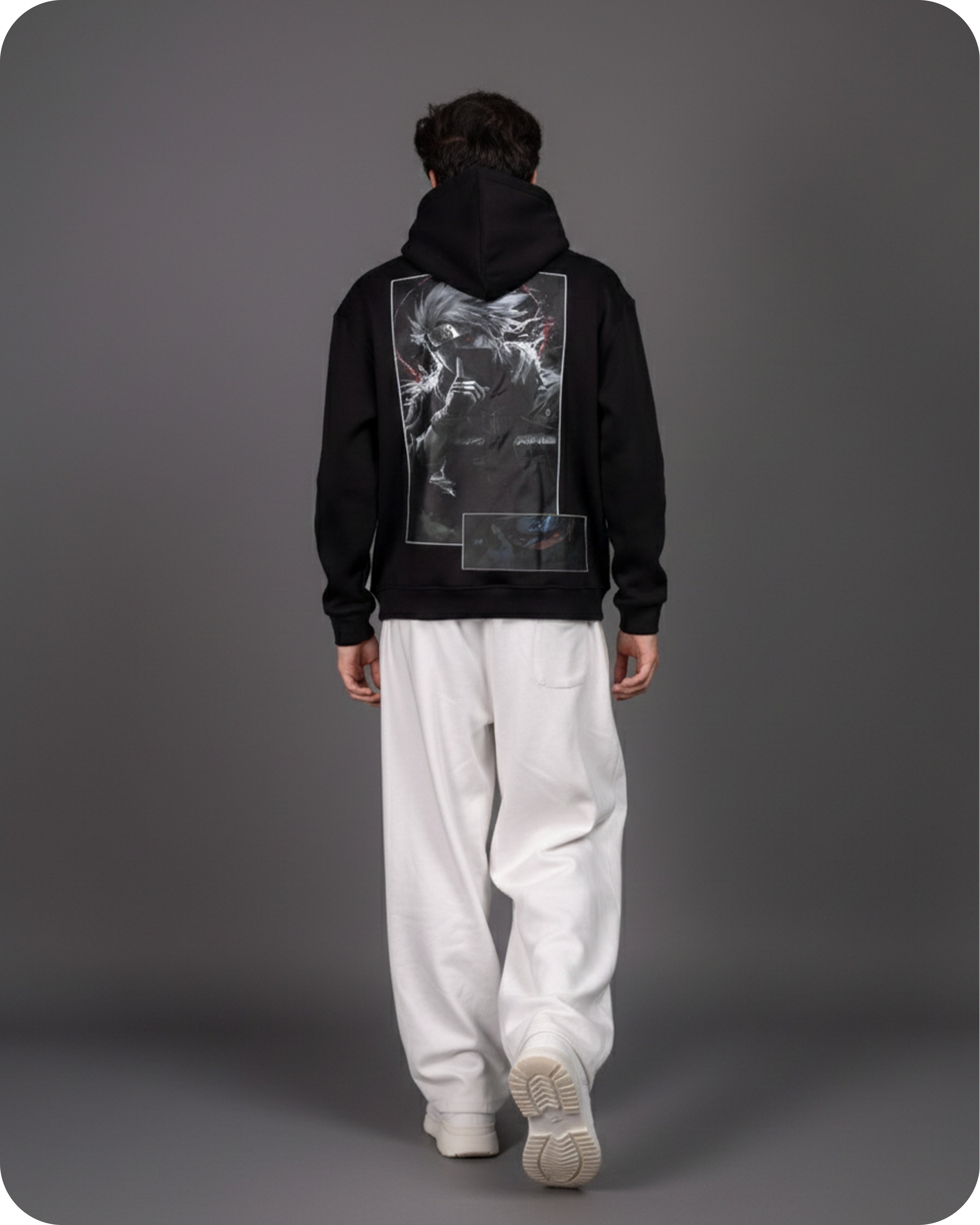 Person wearing a black hoodie with a unique design on the back against a gray background