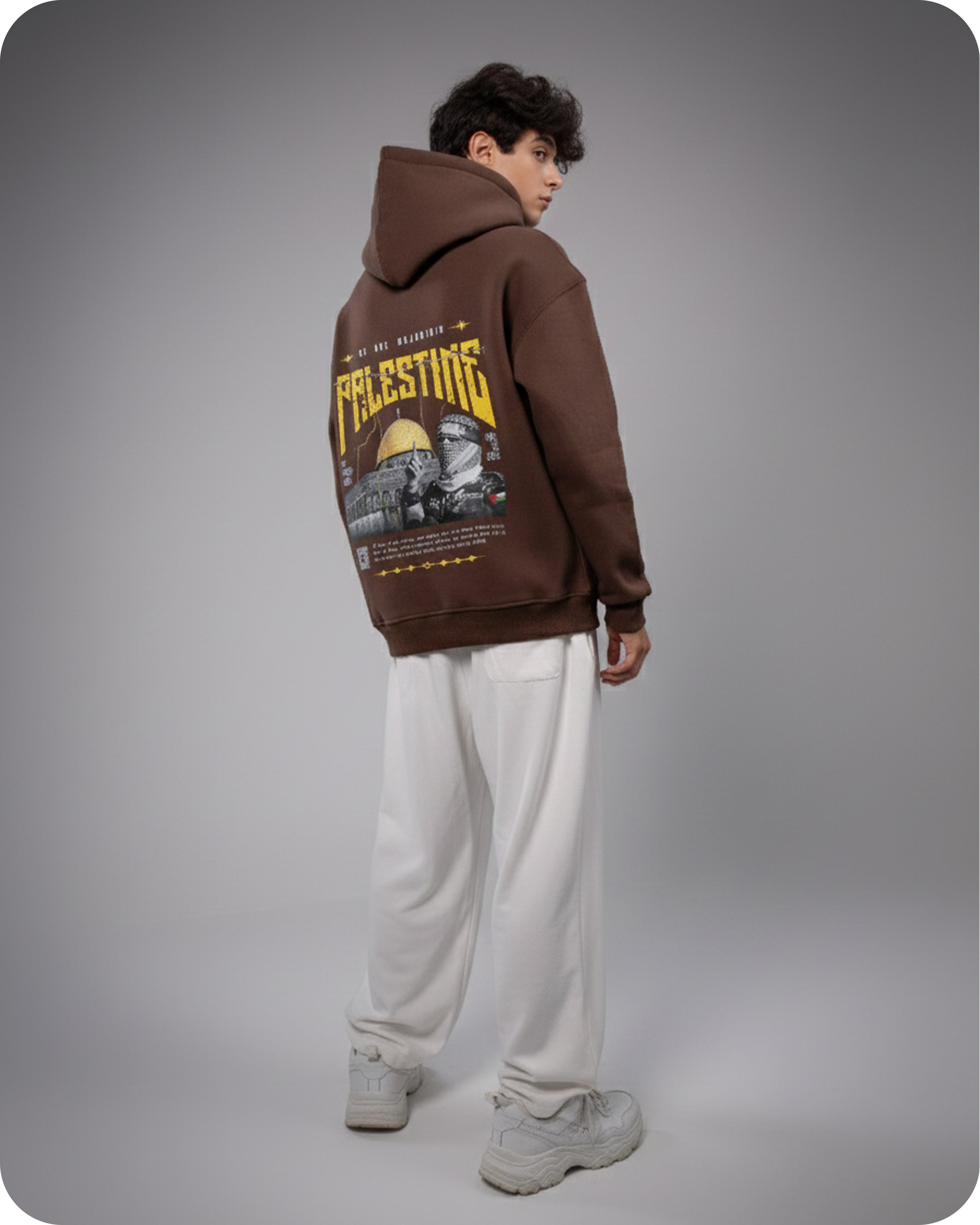 Person wearing a brown hoodie with 'Palestine' printed on the back against a gray background