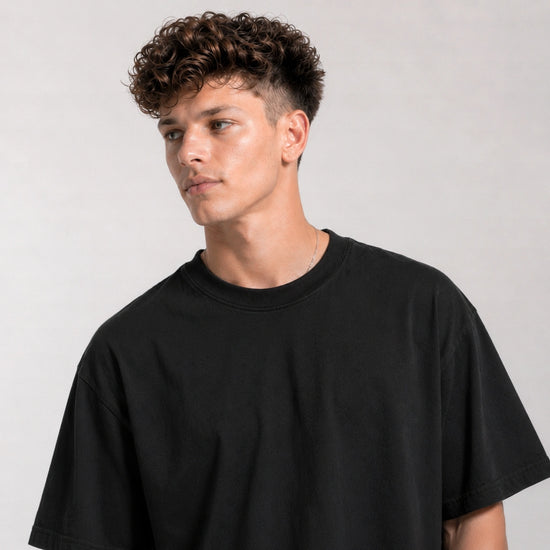Man wearing a black t-shirt against a plain background