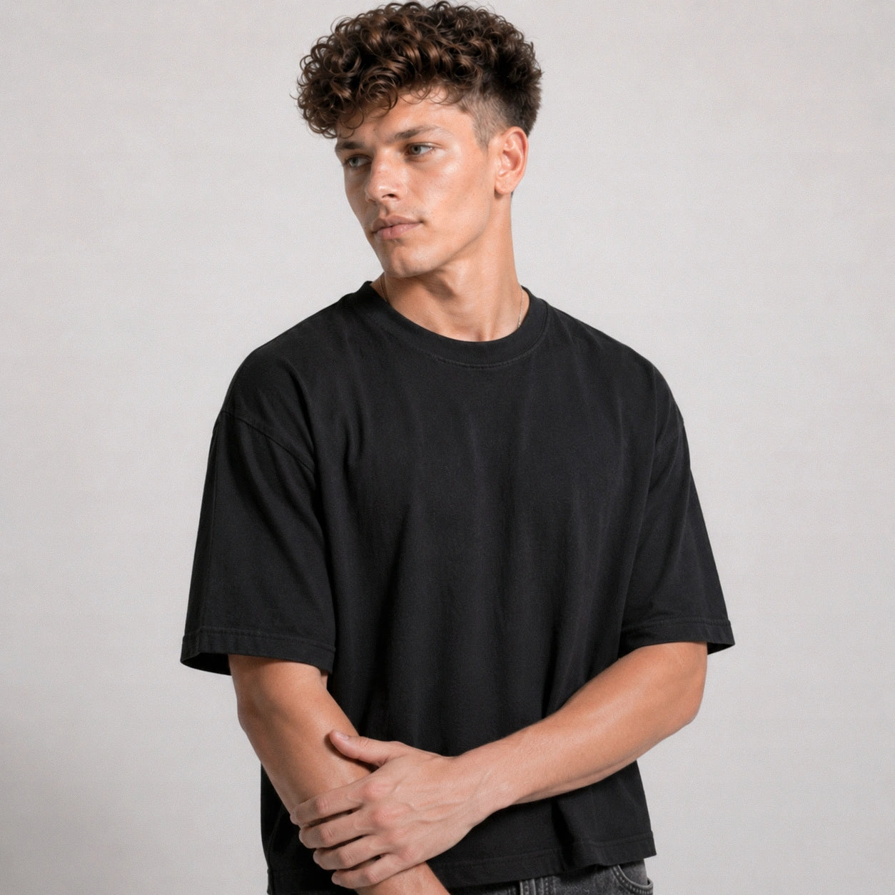 Man wearing a black t-shirt against a plain background