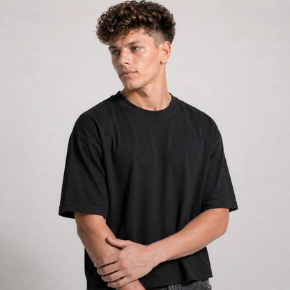 Man wearing a black t-shirt against a plain background