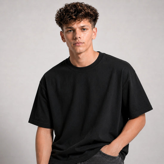 Man wearing a black t-shirt against a plain background
