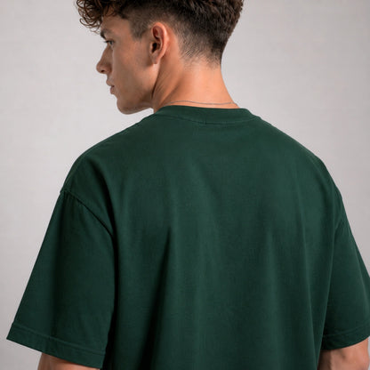 Person wearing a green t-shirt against a plain background