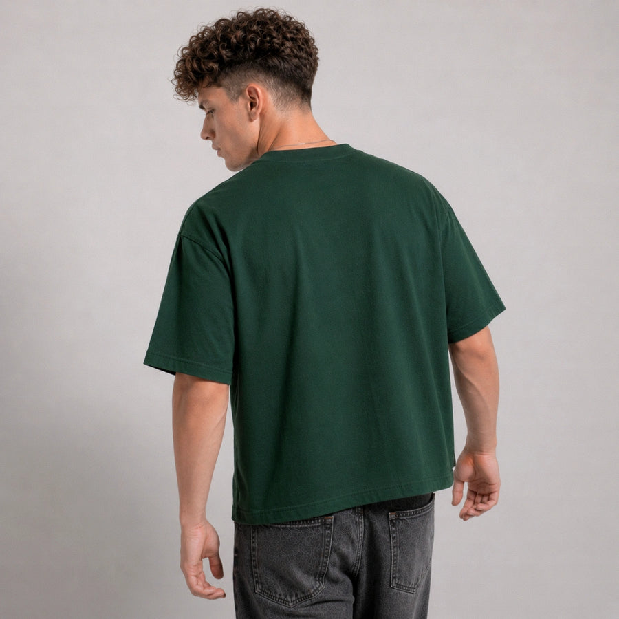Person wearing a green t-shirt on a plain background