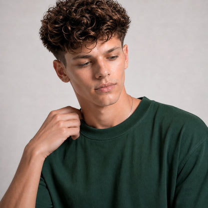 Man wearing a green shirt against a gray background