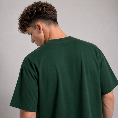 Person wearing a green t-shirt against a gray background