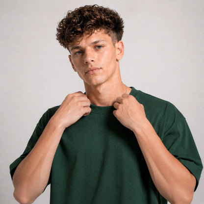 Man wearing a green t-shirt against a plain background