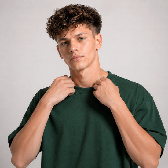 Man wearing a green t-shirt against a plain background