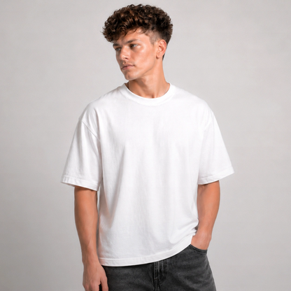 Person wearing a plain white t-shirt against a gray background