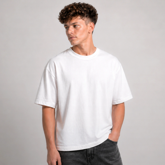 Person wearing a plain white t-shirt against a gray background