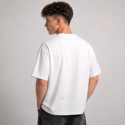 Person wearing a plain white t-shirt on a gray background