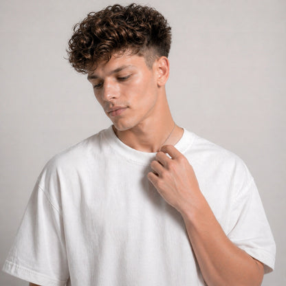 Man wearing a white t-shirt against a plain background
