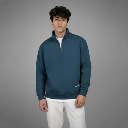 Man wearing a blue pullover with a gray background