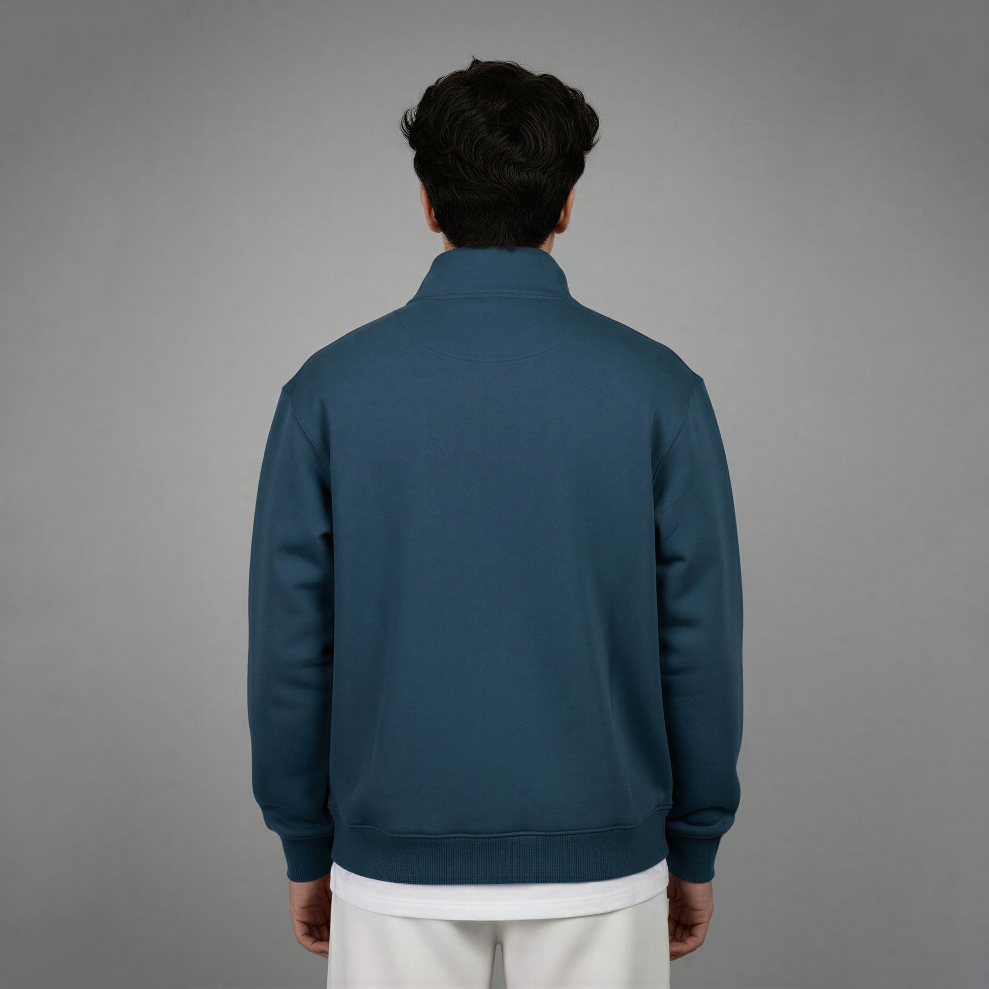 Person wearing a blue jacket on a gray background