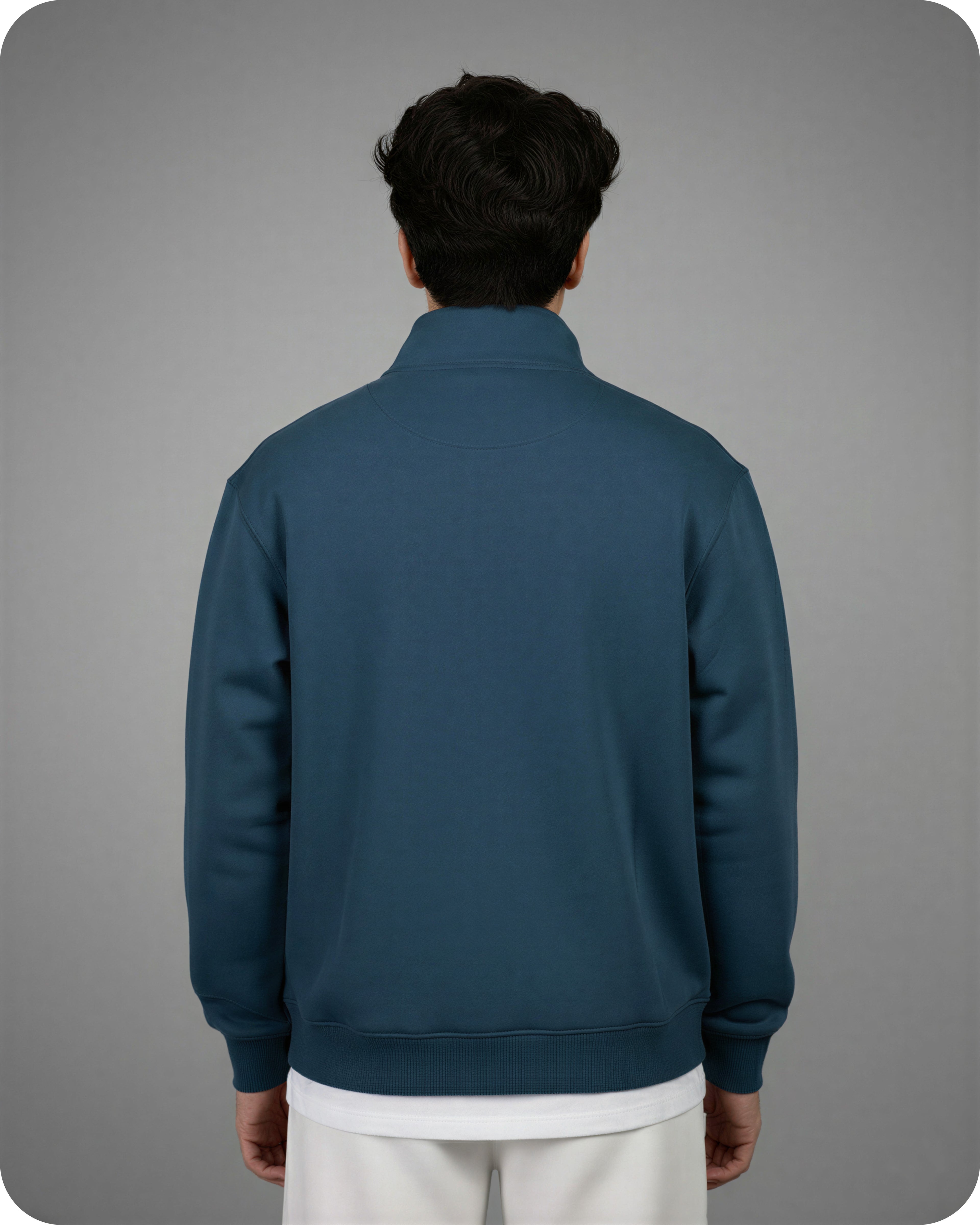 Person wearing a blue jacket on a gray background