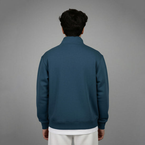 Person wearing a blue jacket on a gray background