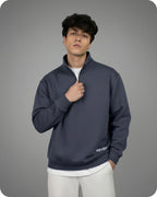 Man wearing a dark blue pullover with 'REVER' branding on a gray background