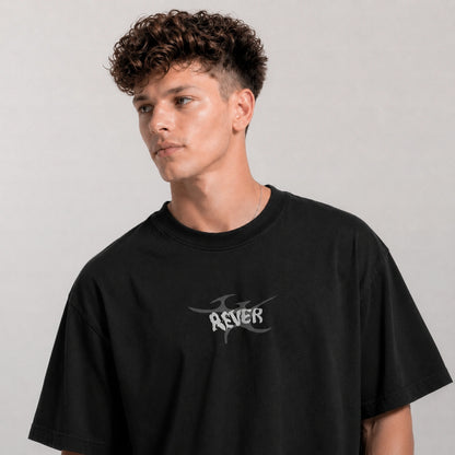 Person wearing a black t-shirt with a logo on a gray background
