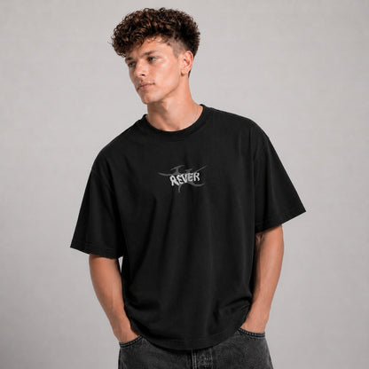 Person wearing a black t-shirt with a logo on a gray background