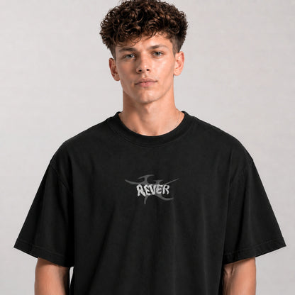Person wearing a black t-shirt with a logo on a gray background