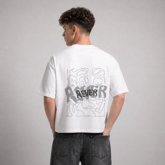 Person wearing a white t-shirt with graphic design on the back against a gray background