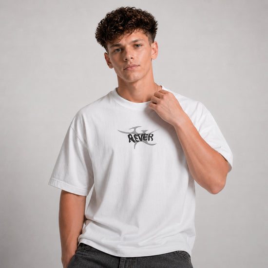 Person wearing a white t-shirt with a logo on a plain background