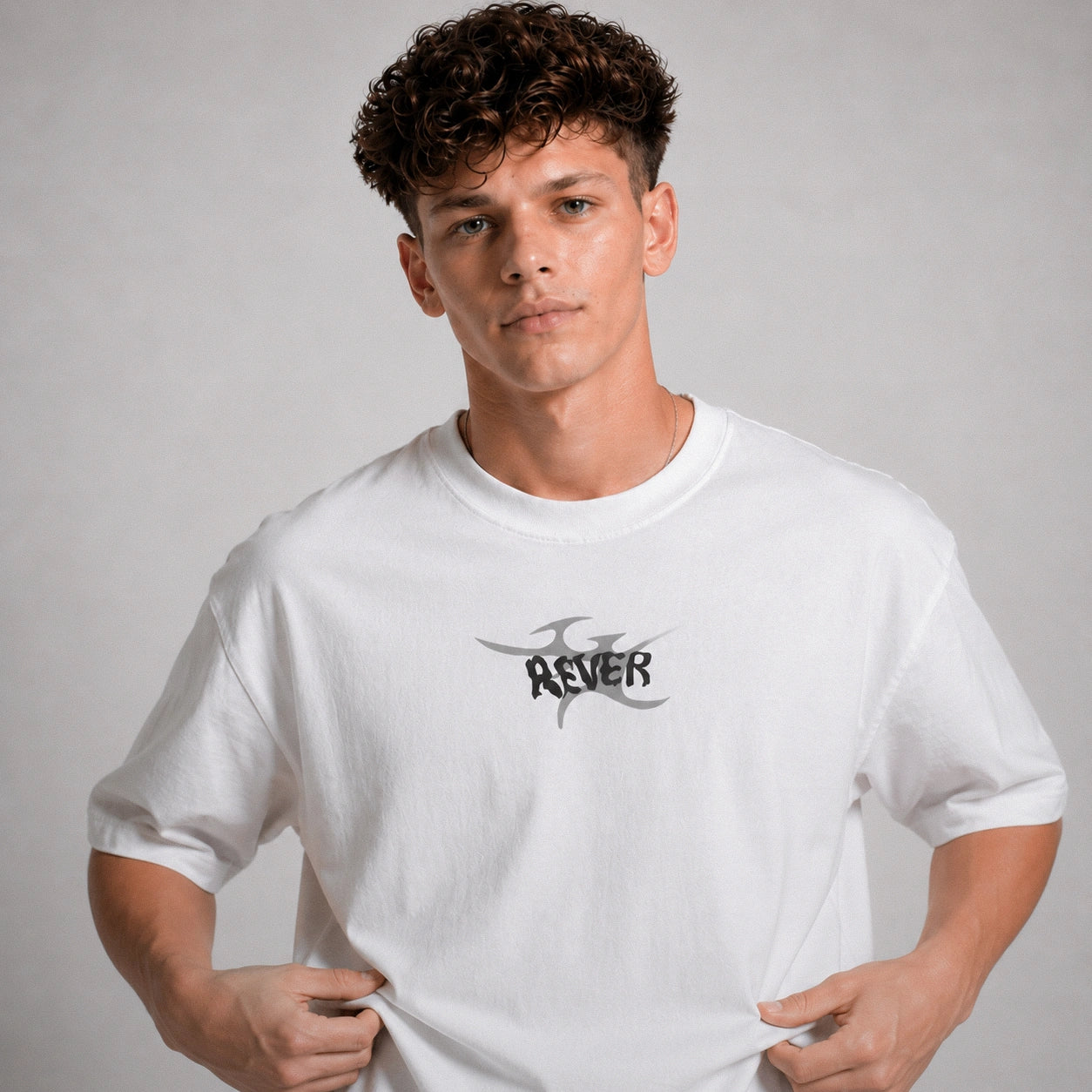 Person wearing a white t-shirt with a logo on a gray background