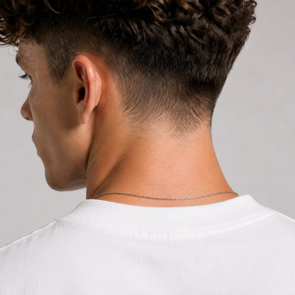 Close-up of a person's neck and shoulders with a neutral background