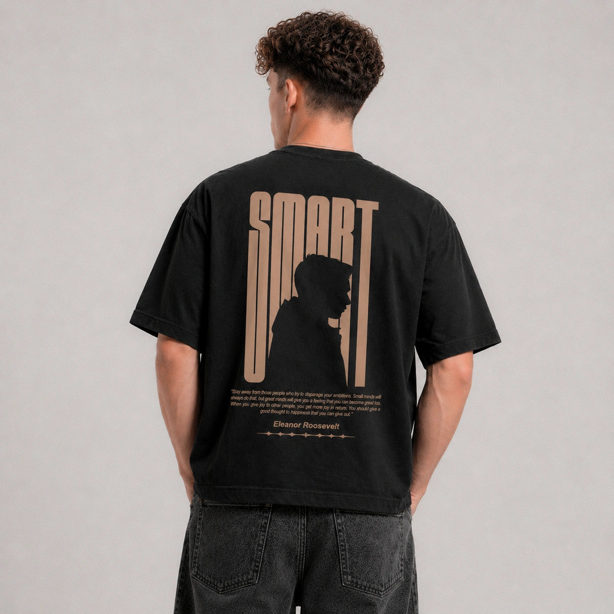 Person wearing a black t-shirt with 'SMART' design on the back against a gray background
