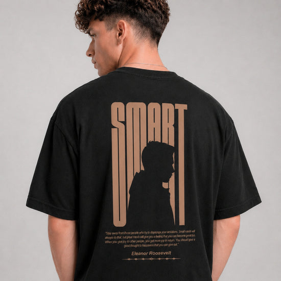 Person wearing a black t-shirt with 'SMART' design on the back, standing against a gray background.