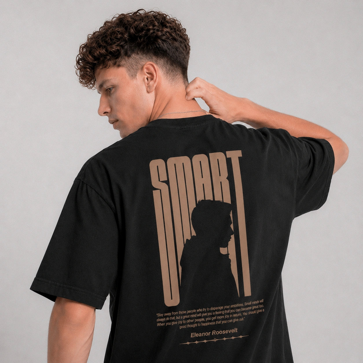 Person wearing a black t-shirt with 'SMART' text and silhouette design on the back, against a plain background.