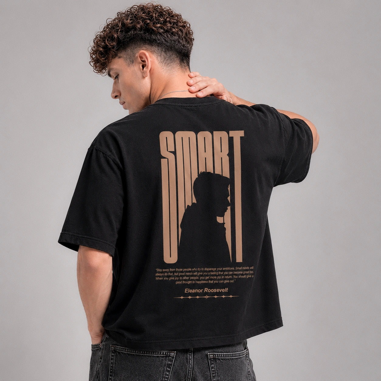 Person wearing a black t-shirt with 'SMART' design on the back against a gray background