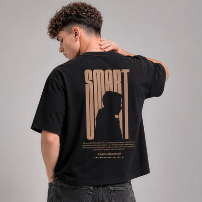 Person wearing a black t-shirt with 'SMART' design on the back against a gray background