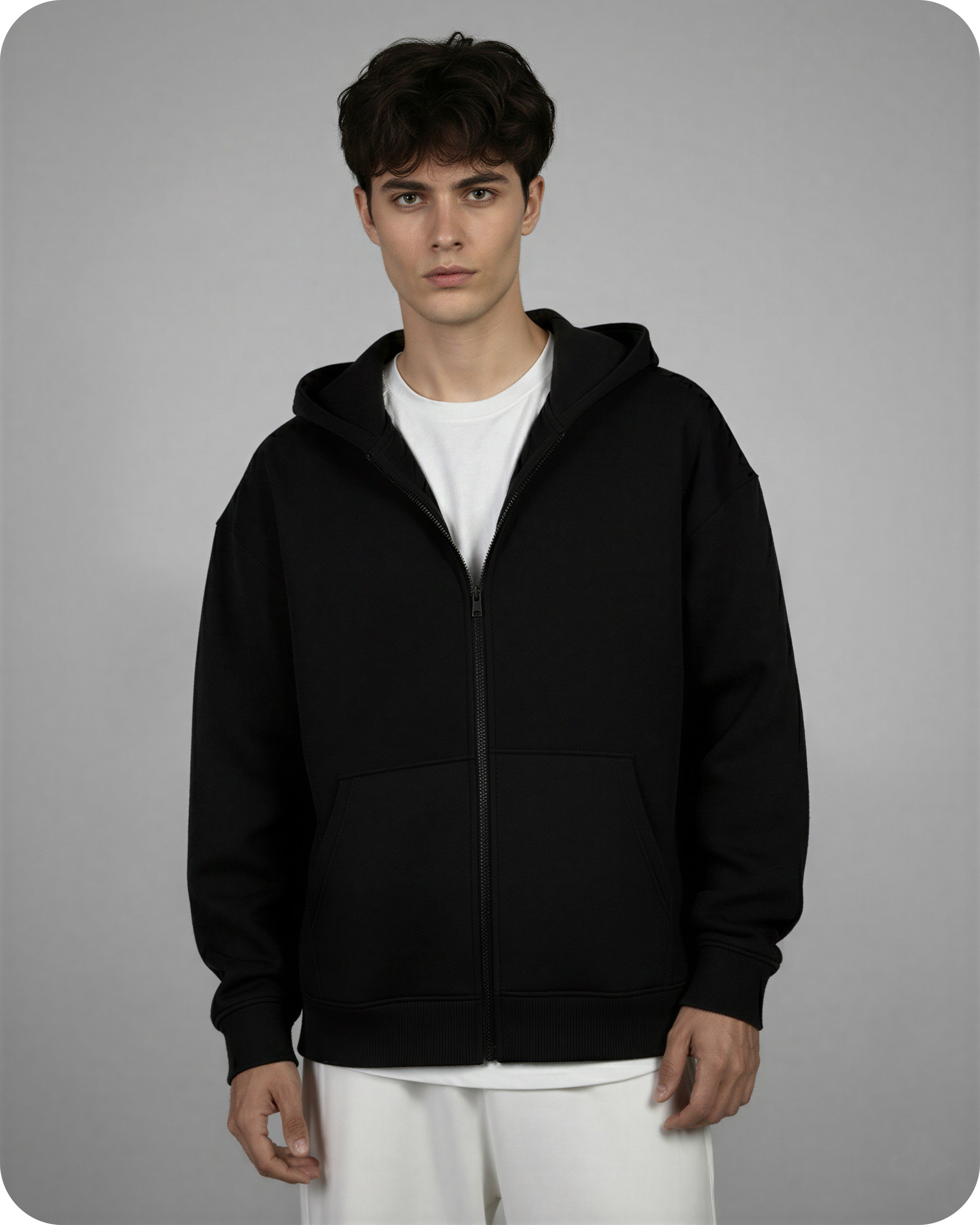 Person wearing a black hoodie on a gray background