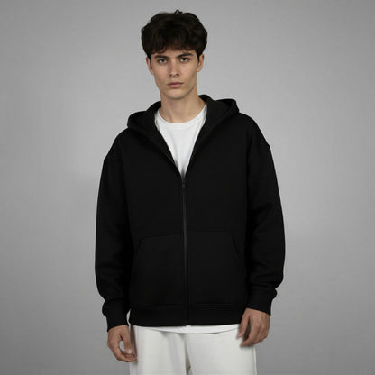 Person wearing a black hoodie on a gray background