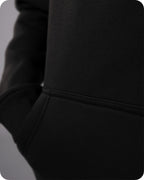 Close-up of a black hoodie with a blurred background